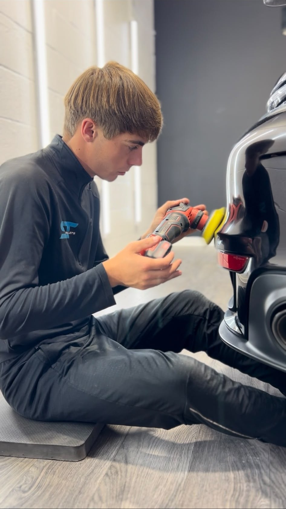 ST Valets detailer machine polishing the paintwork on a car in the studio
